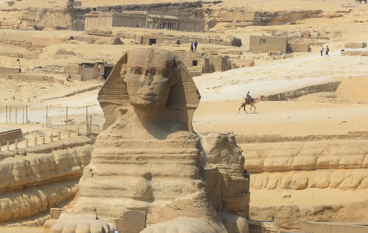 The Great Pyramids of Giza and the Sphinx under a clear sky, along with artifacts displayed at the Egyptian Museum in Cairo.